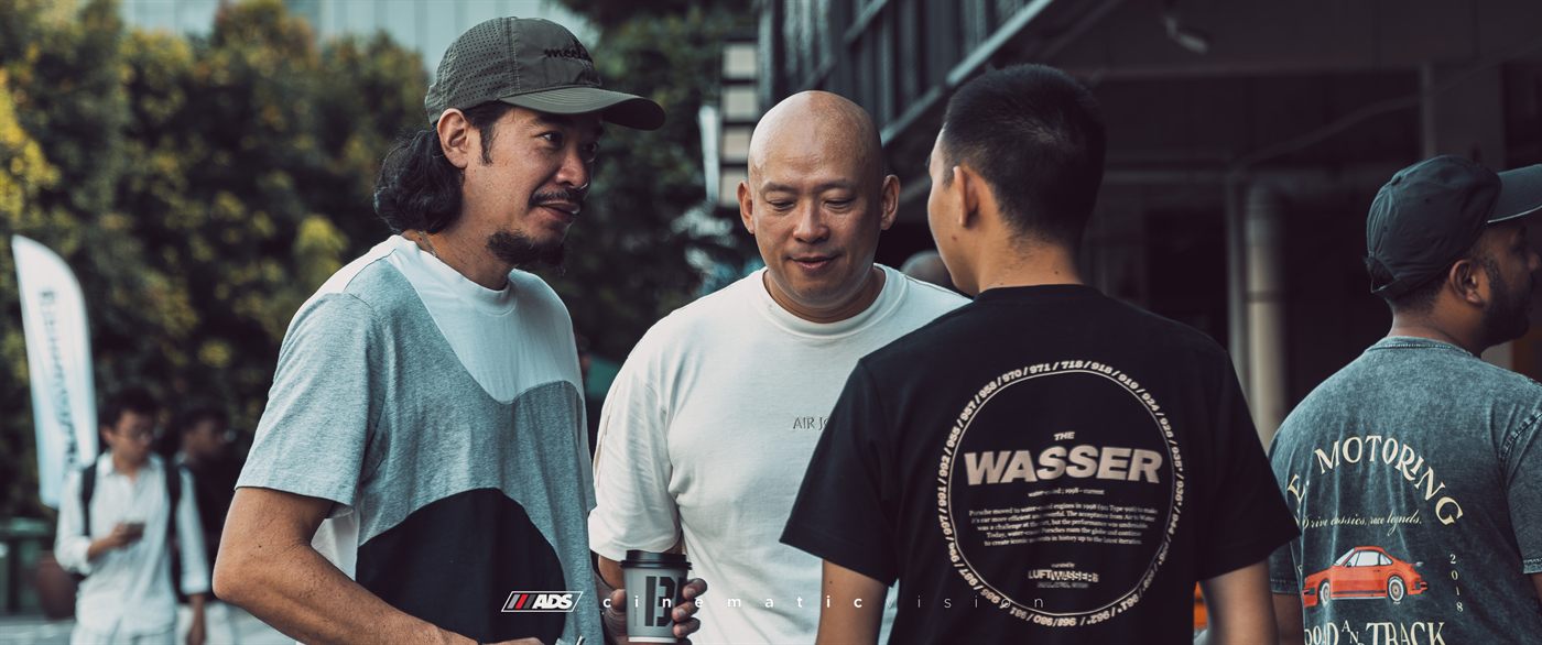 Attendees talking, one wearing a Luftwasser 'The Wasser' tee