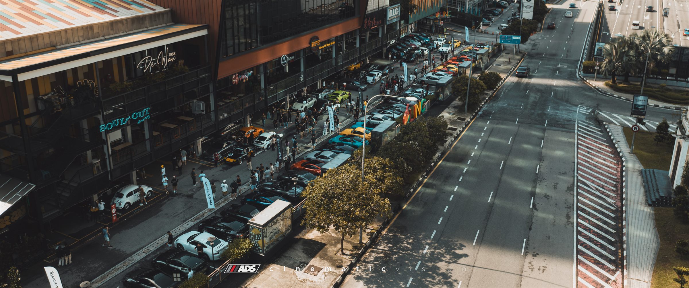 Aerial view of the street lined with Porsches outside the venue